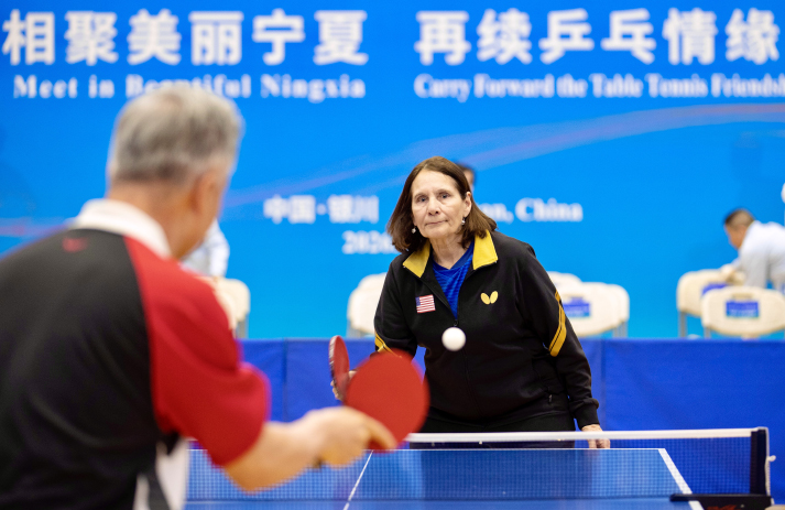Judy Hoarfrost serves the opening ball for the China-U.S. Youth Table Tennis Friendship Match at Ningxia Gymnasium in Yinchuan. Image courtesy of Xinhua.