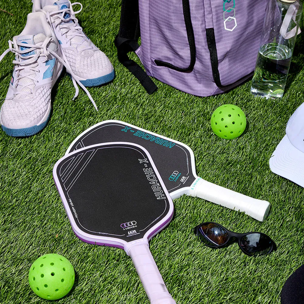 11SIX24 Hurache-X Power 2 Pickleball Paddle - White and Lavender paddles on grass with pickleballs